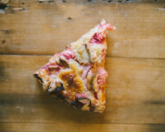 Tangy Rhubarb chunks nestled in a creamy cake, all wrapped up in a delectable pastry crust.