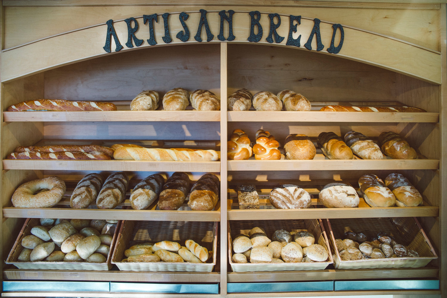 display case showing artisan breads and other baked goods