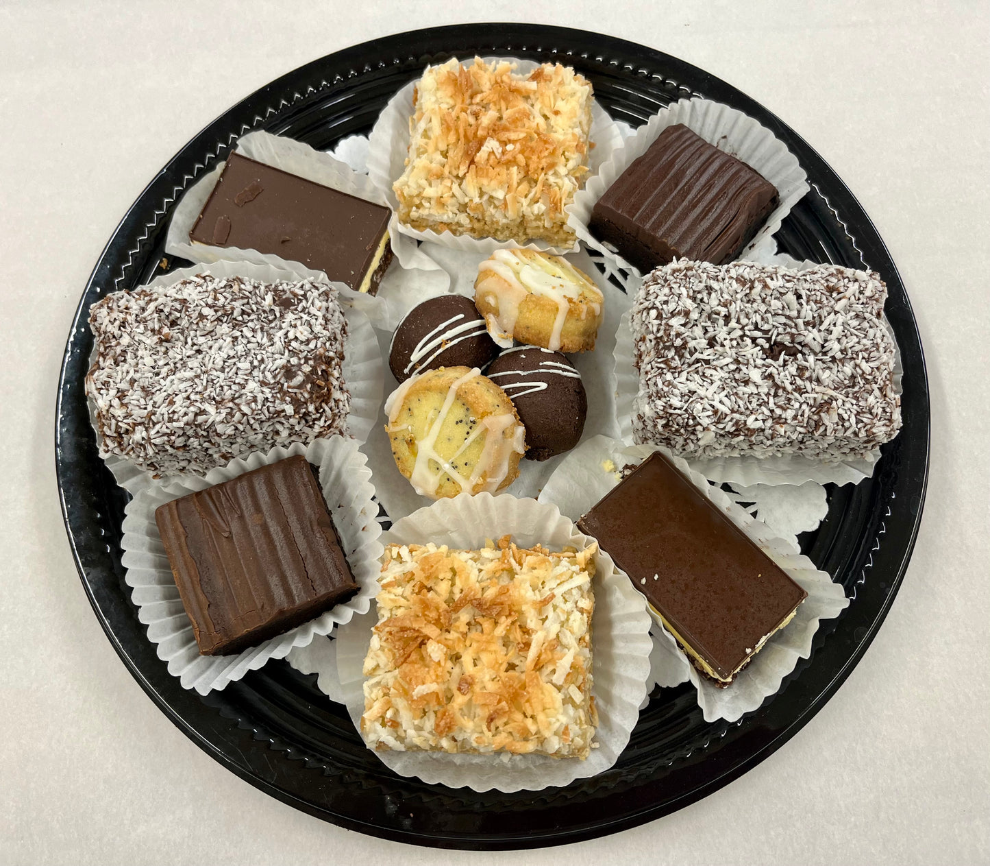 2 brownies, 2 lemon poppyseed shortbread, 2 cocoa balls (gluten friendly), 2 lemon coconut squares, 2 nanaimo bars and 2 lamingtons