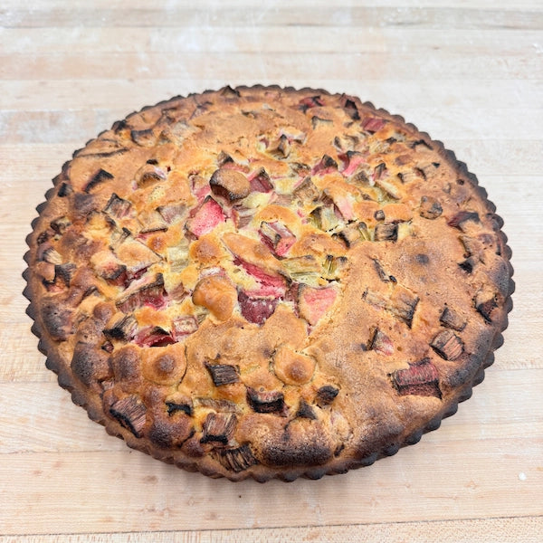 Tangy Rhubarb chunks nestled in a creamy cake, all wrapped up in a delectable pastry crust.