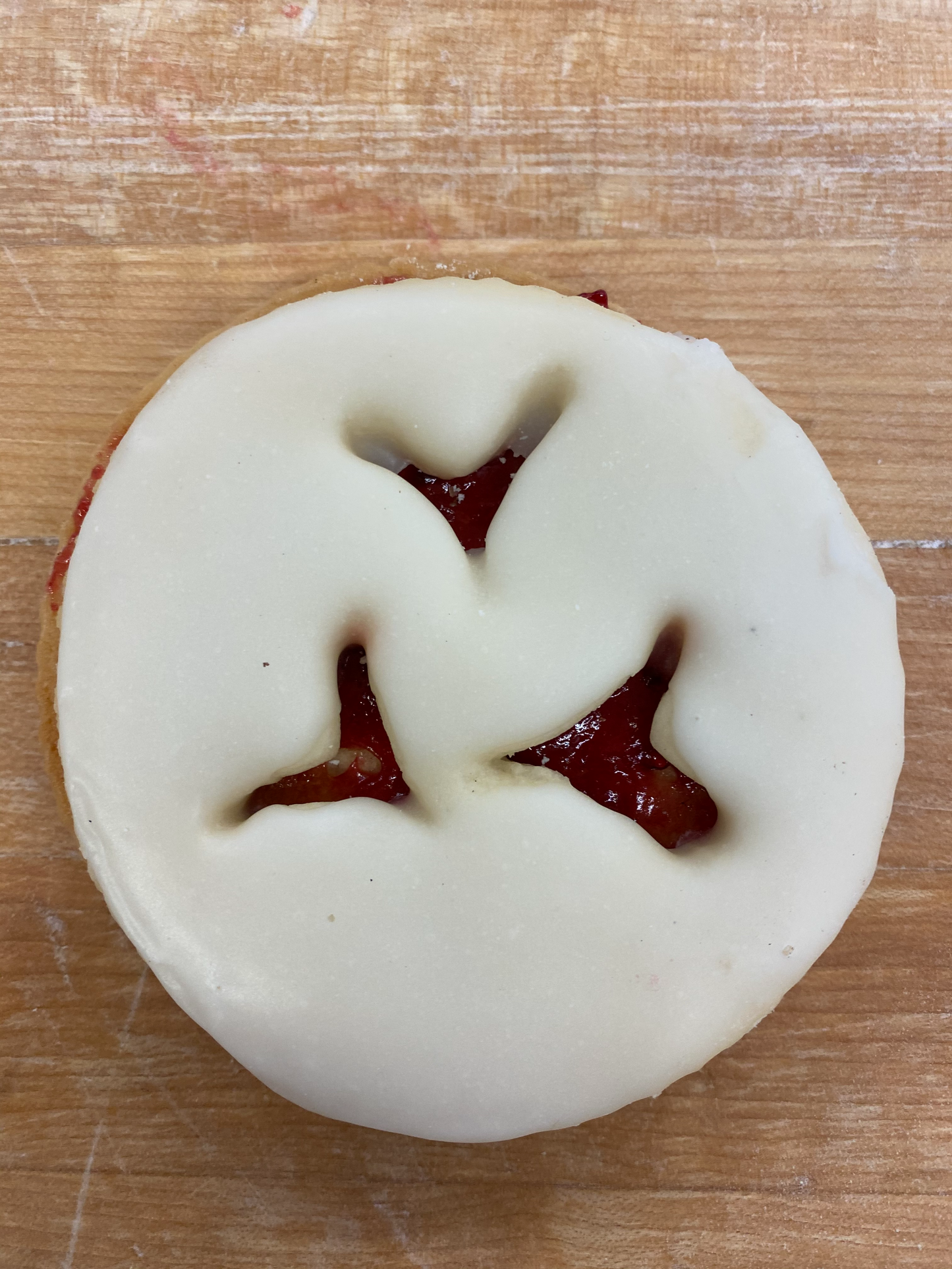 Two layers of sugar cookie with a raspberry filling and glazed with icing