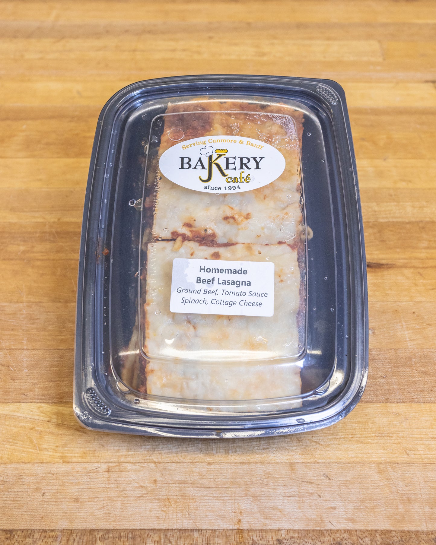 JK Bakery Meat Lasagna with spinach and cottage cheese in a take-out container